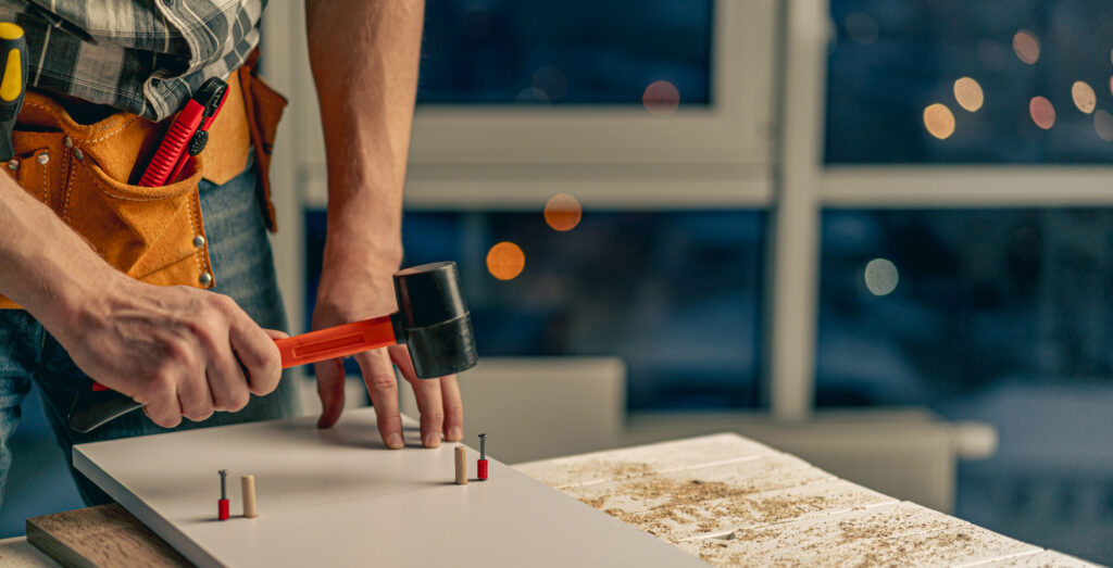 man working during process of furniture manufacturing